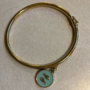 Kate Spade gold toned hinged bangle with enamel fish charm. Hardly worn.